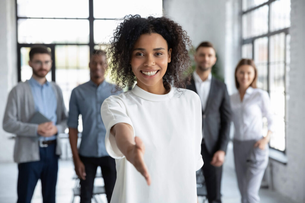 Woman with property management company in Maryland extends her hand to shake on a business deal with property owner.