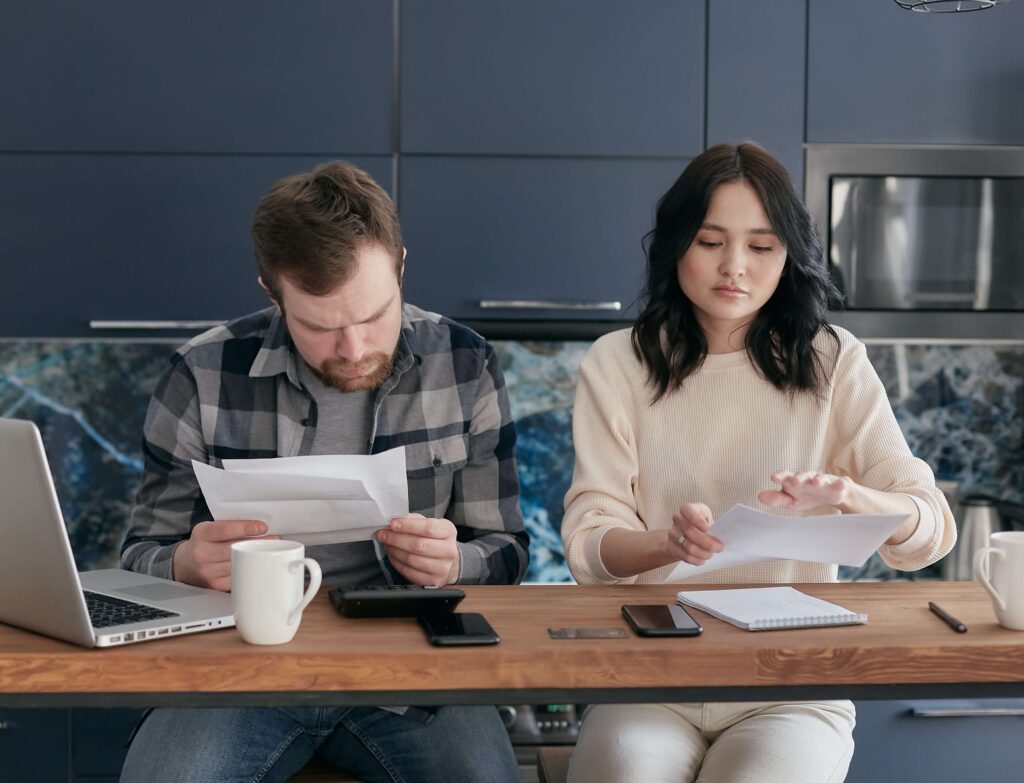 A couple making calculations about affording to purchase an apartment building.