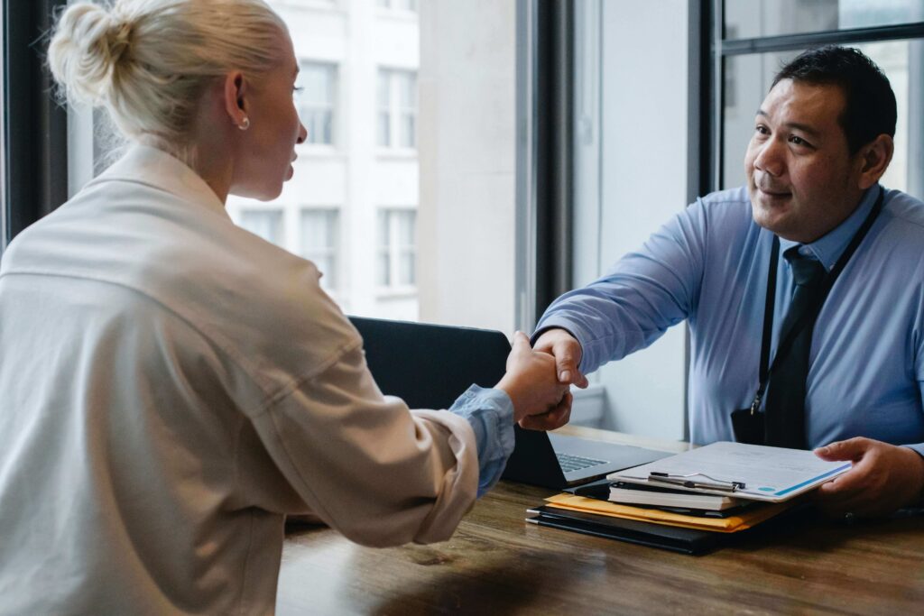 Landlord shaking hands with their property manager in Maryland.